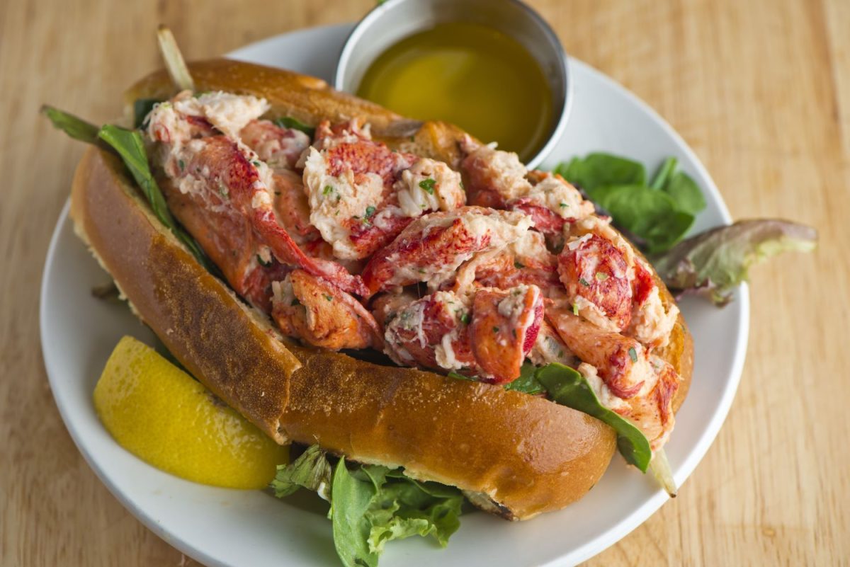 Lobster roll with lemon, lettuce, and butter